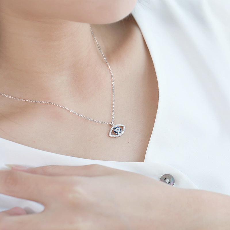 Silver evil eye pendant with blue stones
