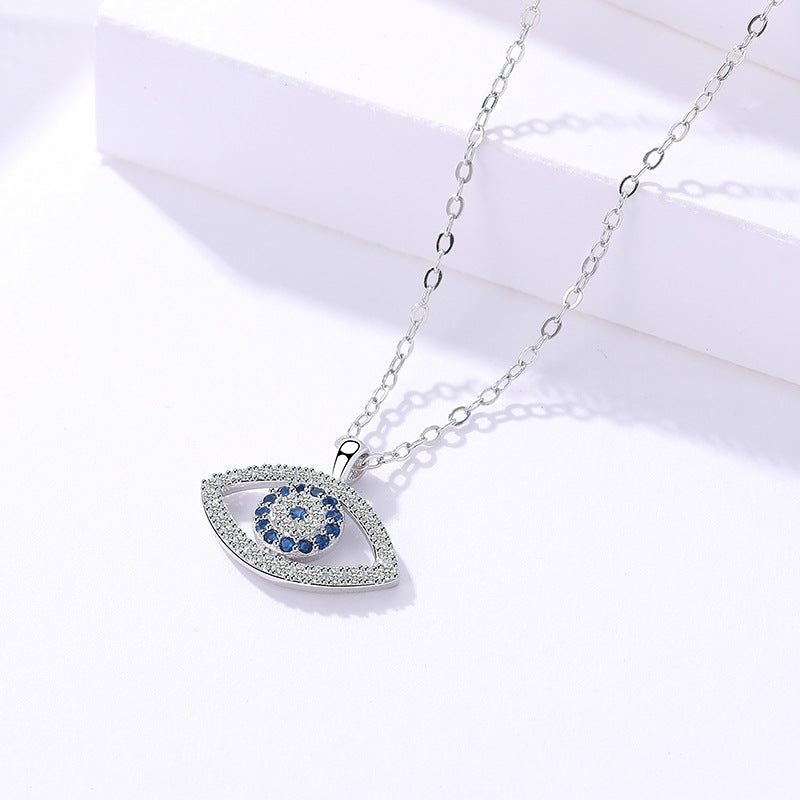 Silver evil eye pendant with blue stones