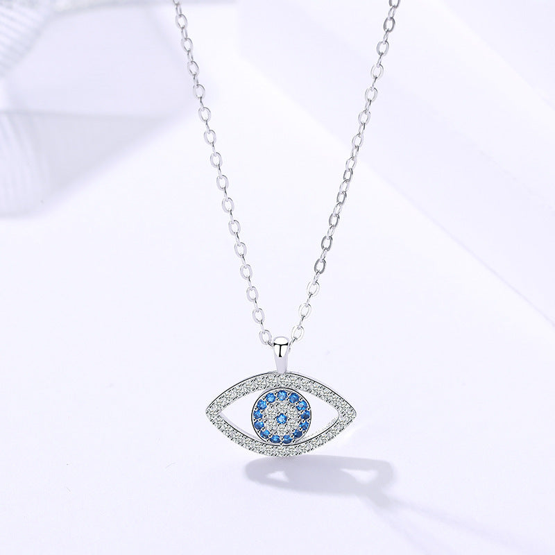 Silver evil eye pendant with blue stones